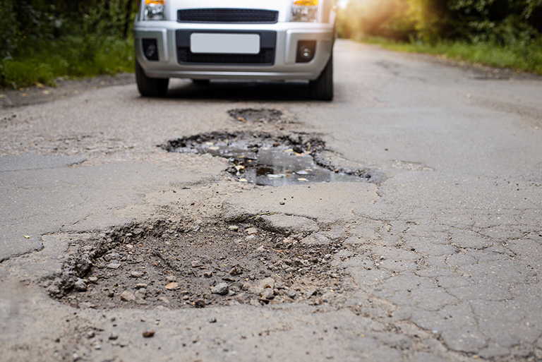 Potholes and cracked pavement - End The Cycle Of Constant Pavement Repairs